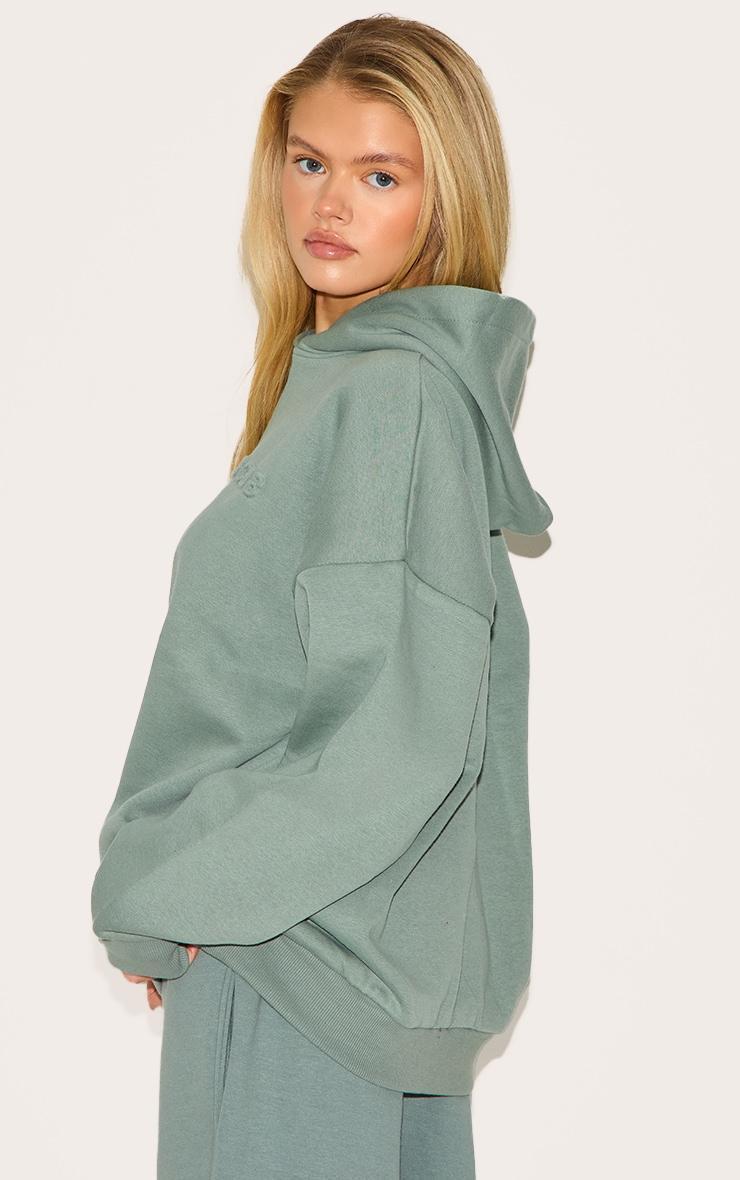 PRETTYLITTLETHING Sage Athletics Club Embossed Graphic Oversized Hoodie Product Image