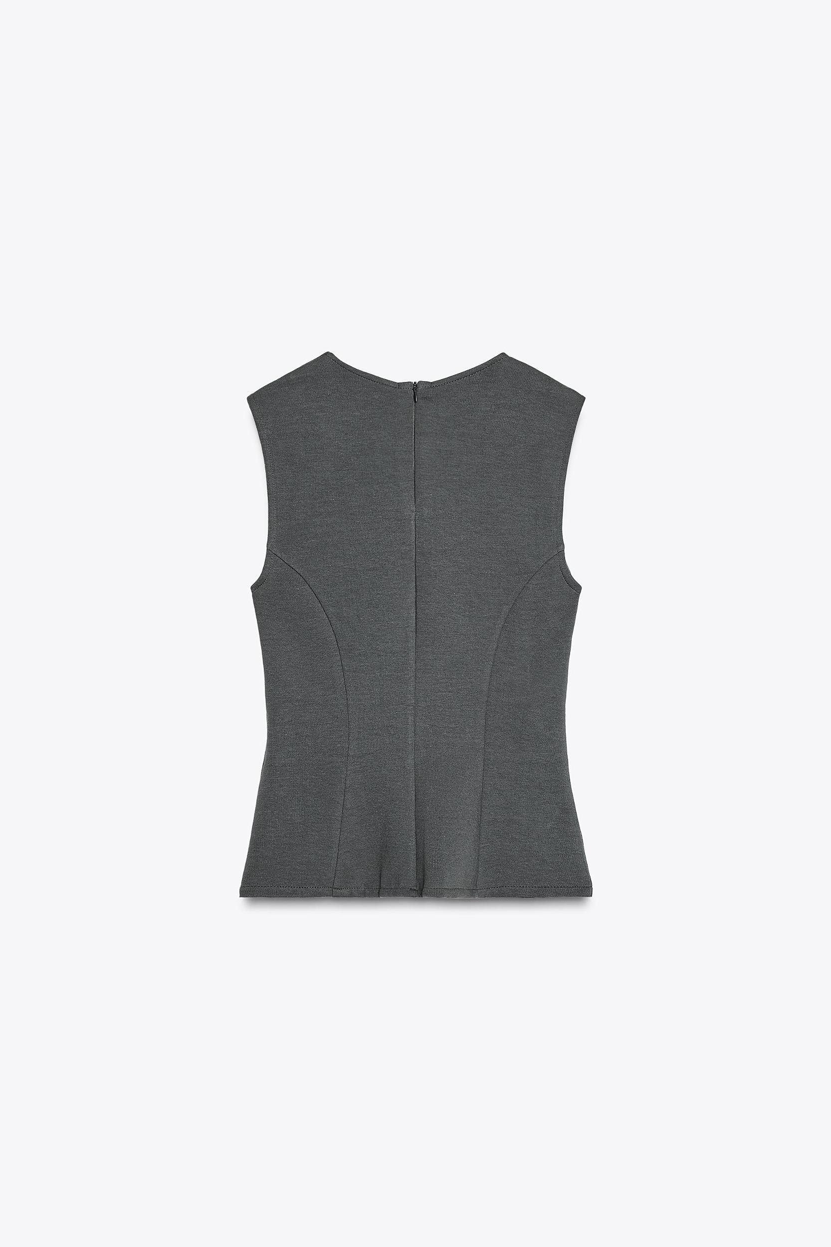 PEPLUM INTERLOCK TOP Product Image