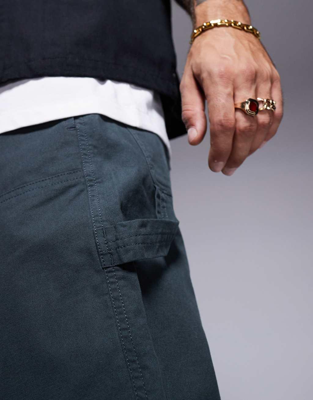 ASOS DESIGN baggy fit chino pants with carpenter detail in khaki Product Image