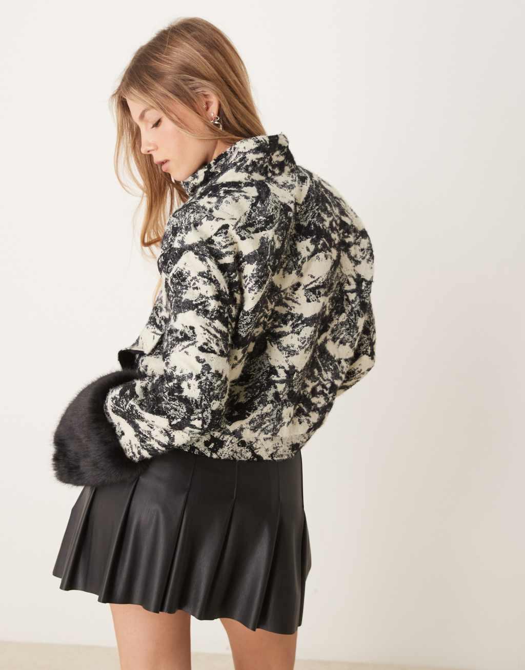 Ghospell faux fur cuff funnel jacket in black and white Product Image