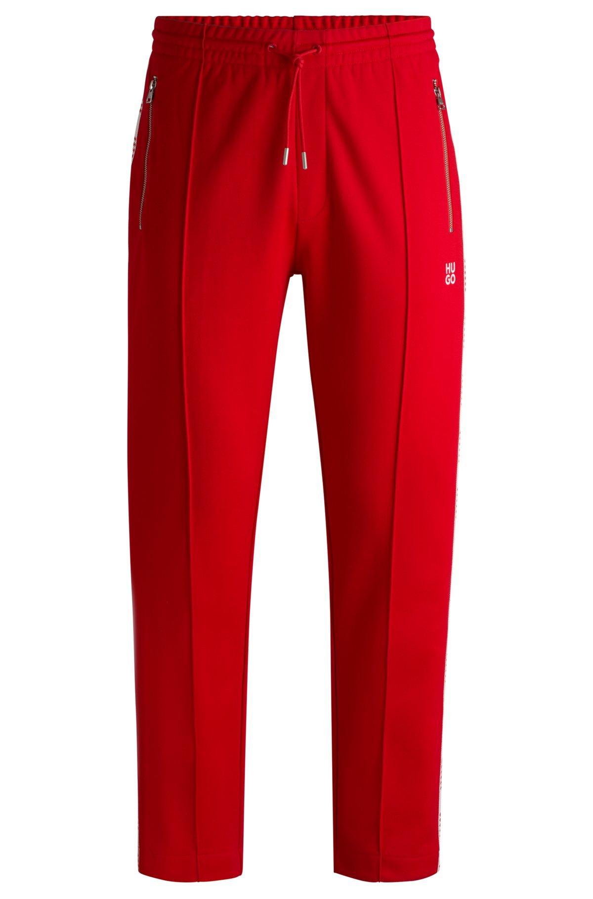 HUGO - Tracksuit bottoms with checked tape - light pink Product Image
