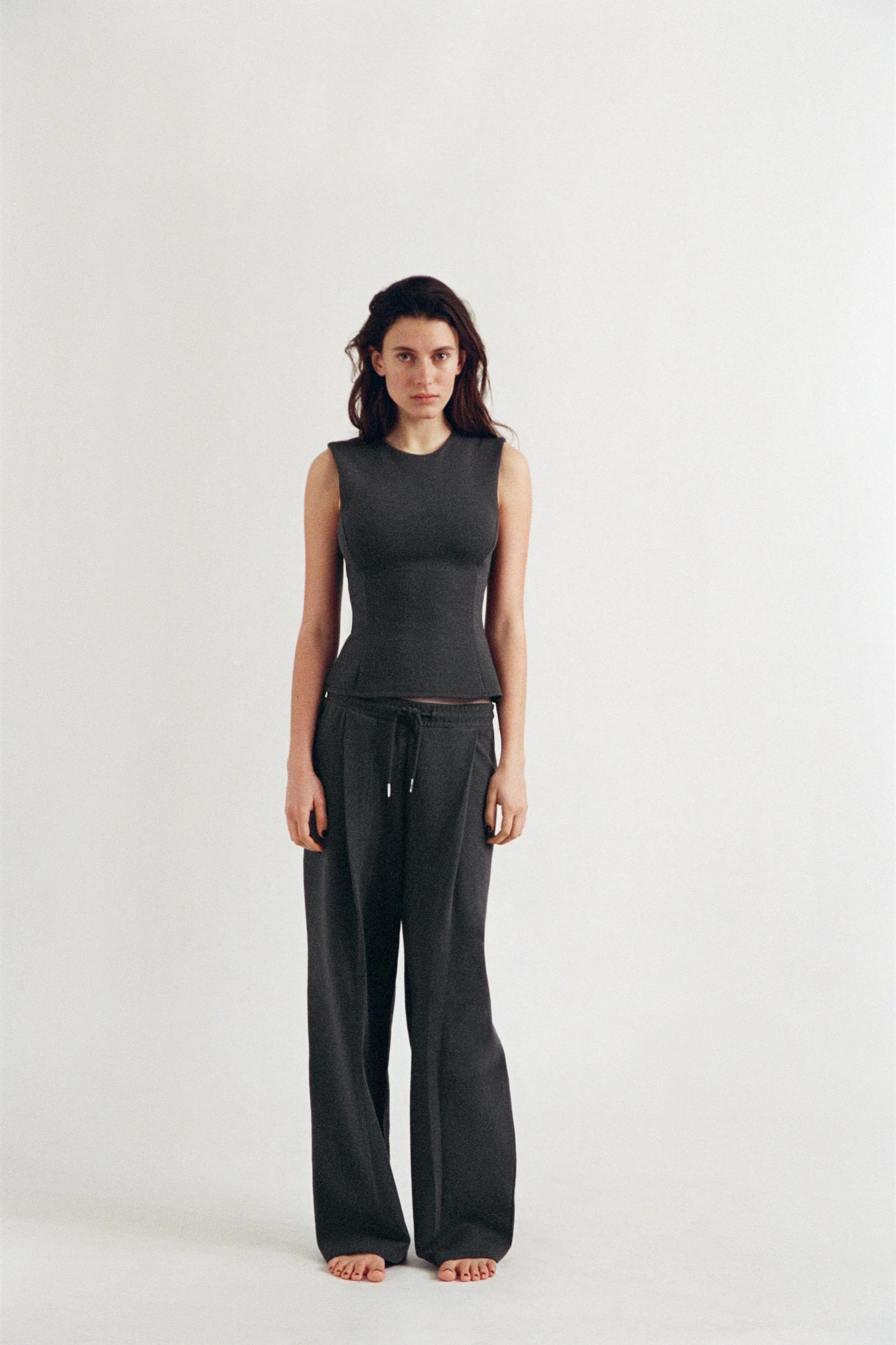 PEPLUM INTERLOCK TOP Product Image