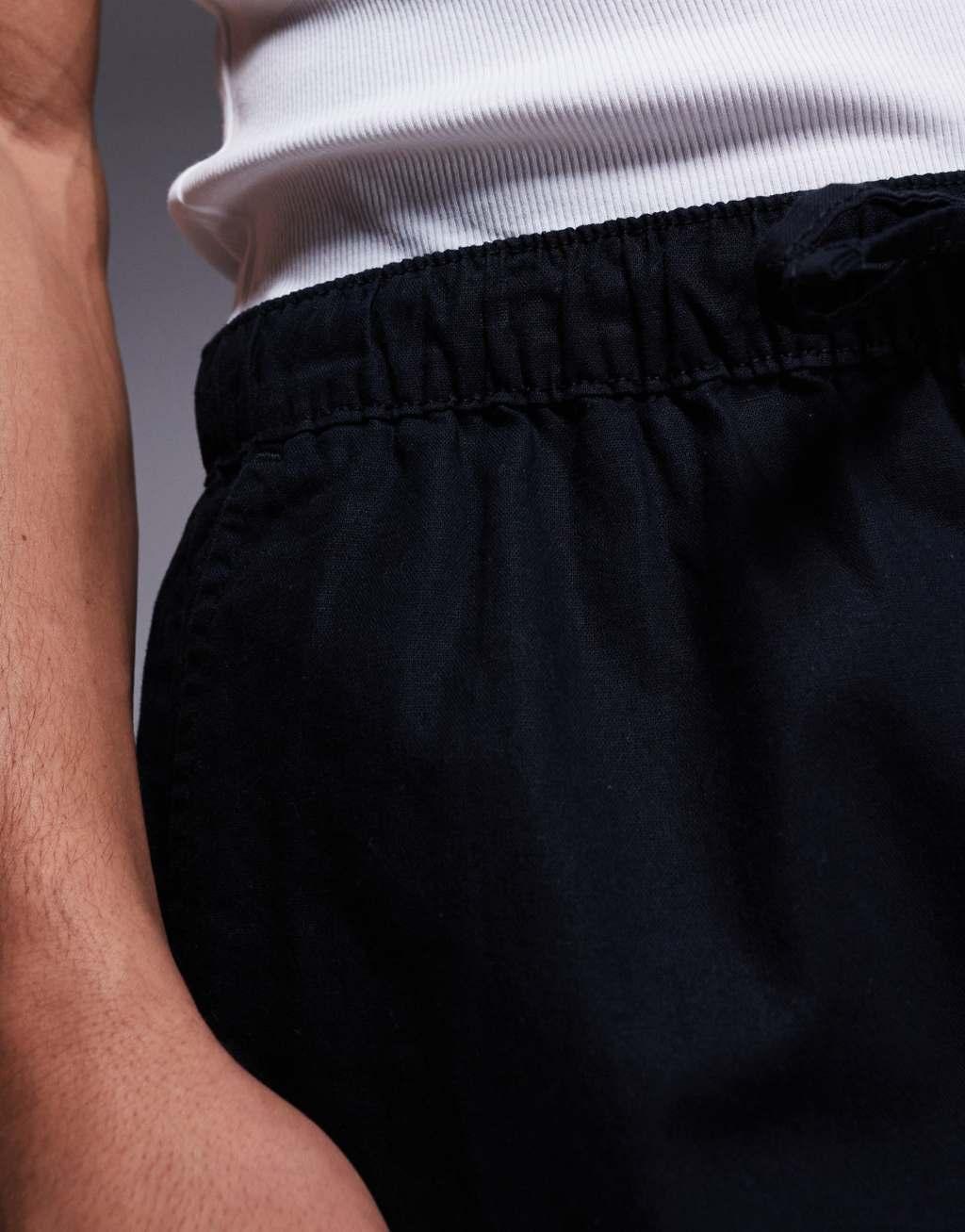 ASOS DESIGN shorter length linen blend shorts in black Product Image