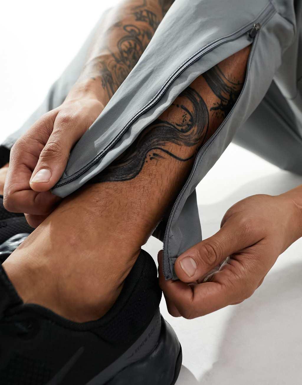 Nike Running Challenger woven sweatpants in gray Product Image