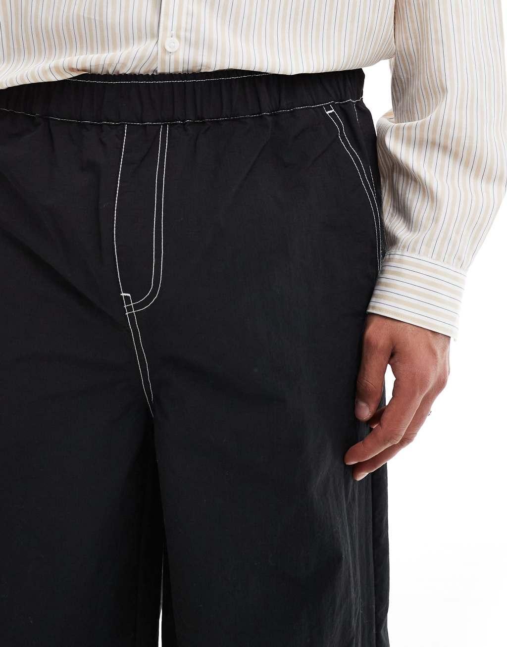 ASOS DESIGN baggy pants in black nylon with contrast stitch Product Image