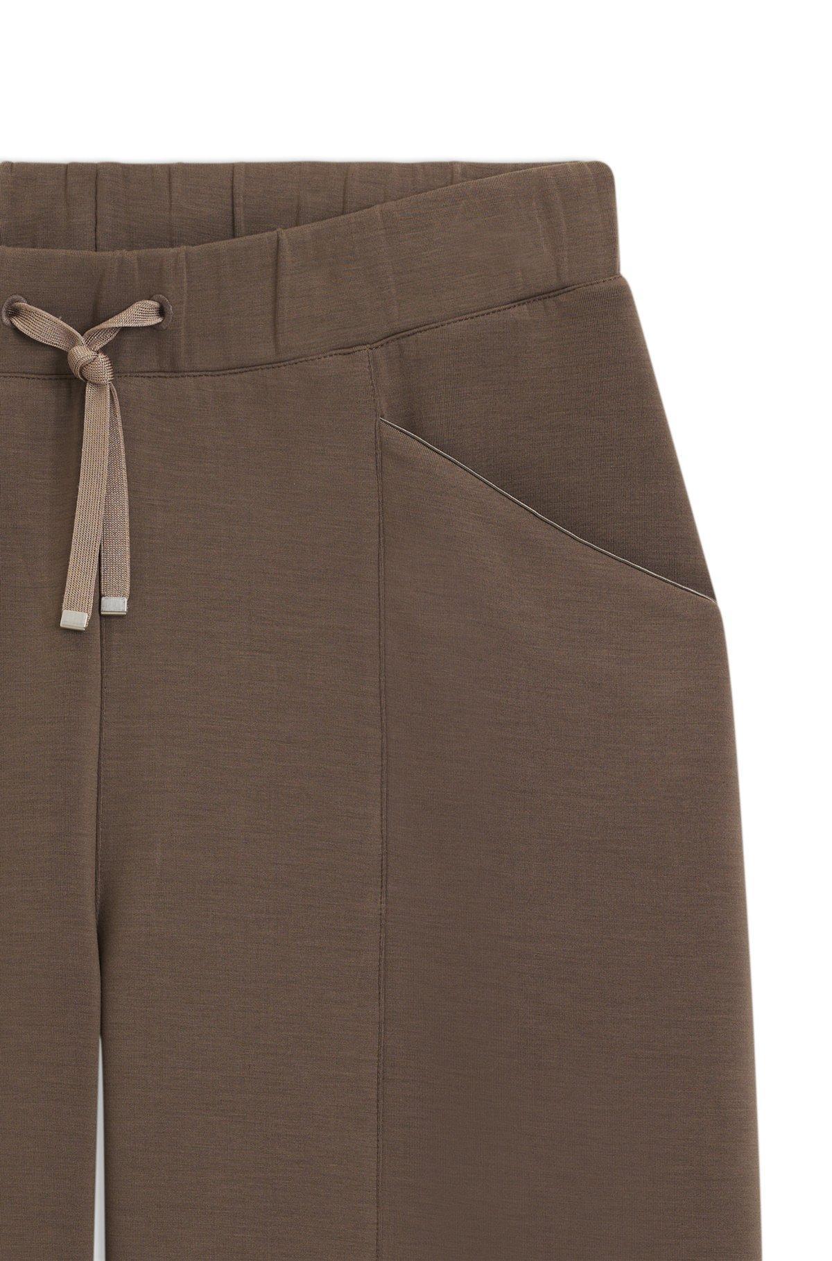 Relaxed-fit tracksuit bottoms with lustrous piping Product Image